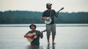 Okee Dokee Brothers Can You Canoe? DVD Image of one brother in water and other standing on top of water