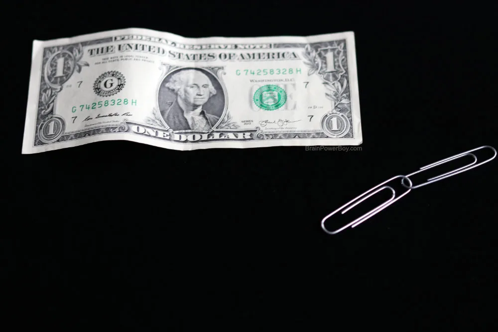 dollar bill and two paperclips for jumping paperclips magic trick