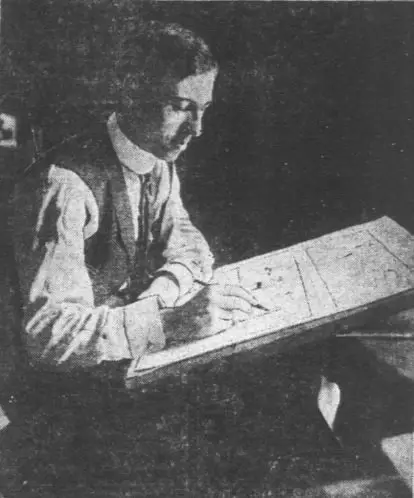Picture of Rube Goldberg working at his desk.