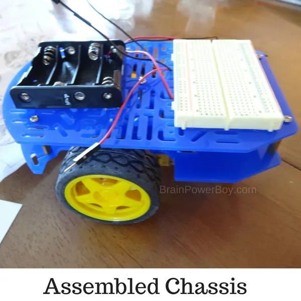 Working on assembling the chassis for our super fast light following robot. (ad with Home Science Tools)