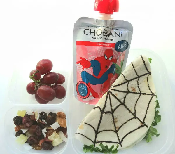 Take a cheese sandwich and give it a superhero twist. This Spiderman sandwich is made with a tortilla and includes plenty of white cheese and lettuce. A fruit selection and Chobani Kids Greek Yogurt strawberry pouches, make the lunch even more nutritious and tasty. Created by BrainPowerBoy.com, sponsored by Chobani.