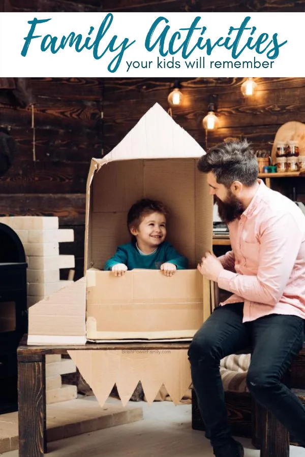 What to do with kids indoors at home. Dad builds cardboard rocket for child.