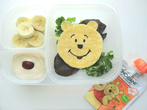 A yummy corn tortilla quesadilla is transformed into Winnie the Pooh in this cute and nutrient packed lunch. Fresh bananas and Chobani Tots Greek Yogurt Banana + Pumpkin pouch, who can say no to real fruits and vegetables that make this a healthy choice! Created by BrainPowerBoy.com, sponsored by Chobani.