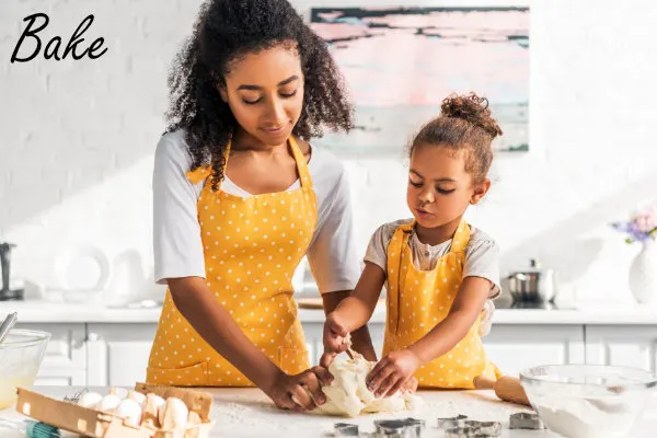 Mom and daughter baking cookies together